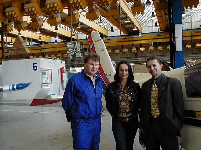 An archive photograph of Patrik with colleagues on an aircraft factory floor